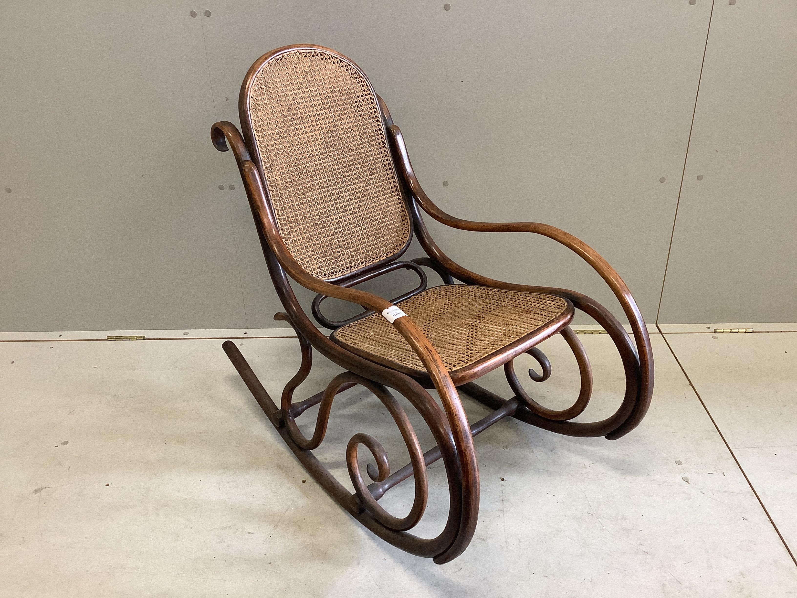 An early 20th century caned Thonet bentwood rocking chair, width 49cm, depth 90cm, height 87cm